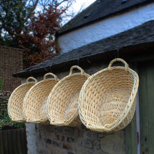 Scottish wicker washing baskets hanging outdoors 